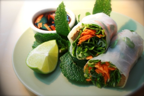 Spring rolls on a plate with lime wedge